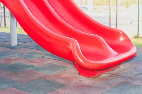 Side view of red plastic slide for children Stock Photos