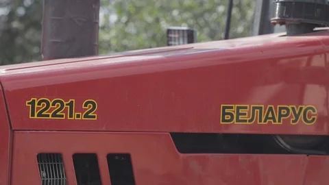 Side view of red tractor in a daylight. close up Stock Footage 122758813