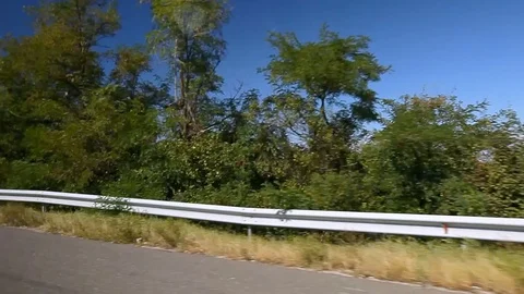 Side View of Road with Crash Barrier and Landscape Stock-Footage 112122992