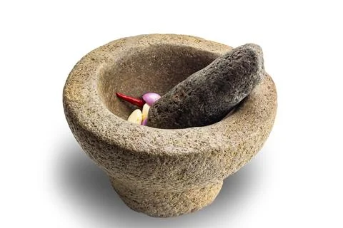 Side view of rock morta with red chilli, onion, garlic and pestle isolated .. Stock Photos