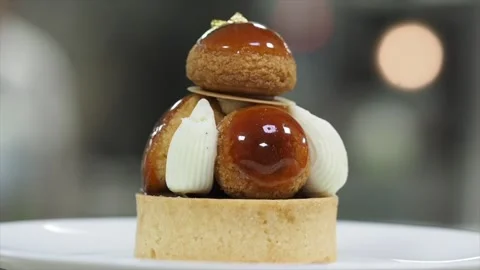 Side View Of A Rotating CHOCOLATE AND CARAMEL CHOUX Dessert Vídeos de archivo 133137863