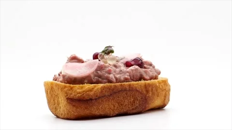 Side View Of A Rotating Gourmet Beef Open Sandwich On A White Background, UK 動画素材 153501236