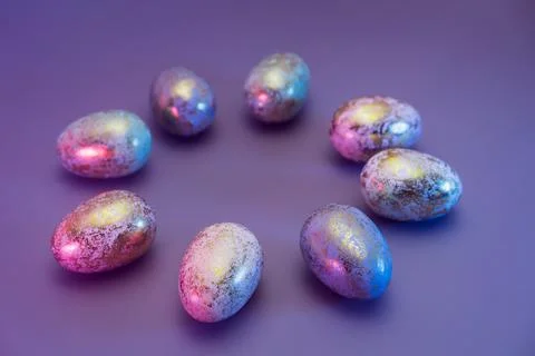 Side view round frame made of Easter golden eggs with different patterns in neon Stock Photos