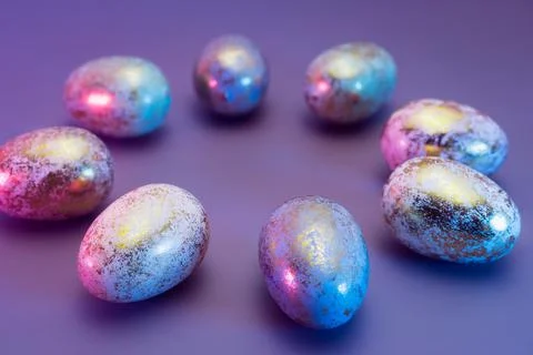 Side view round frame made of Easter golden eggs with different patterns in neon Stock Photos