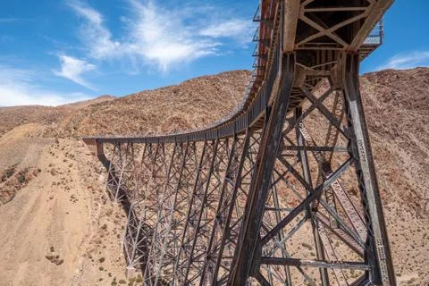 Side view of a rusty railroad bridge. Stock Photos