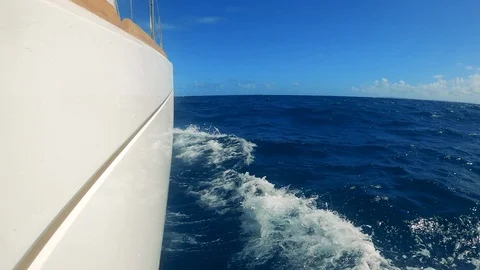 Side view of sailboat's board while crashing against the waves Video stock 126027929