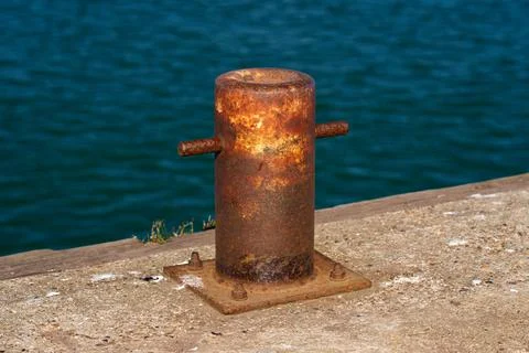 Side view of a samson post style single bitt mooring bollard for boats Stock Photos