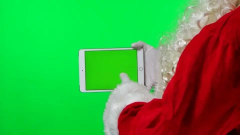 Side view Santa Claus with beard in white gloves uses tablet in horizontal Stock Footage 145545227