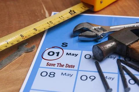 Side view of Save the date text on calendar with working tools background. .. Stock Photos