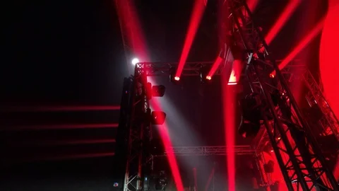 Side view to scene with a light show of many red rotating lights and stroboscope 스톡 동영상 88210794