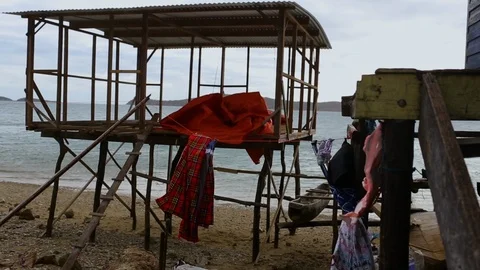 Side view of sea from behind a cottage Stock Footage 100061176