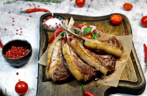 Side view. selective focus Fried lamb ribs are on the board. Stock Photos