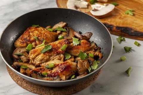 Side view selective focus image of sauteed roasted chicken breasts in a pan Stock Photos