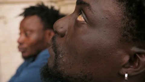 Side view on serious sad young hooded black african migrant Stock Footage 218758392