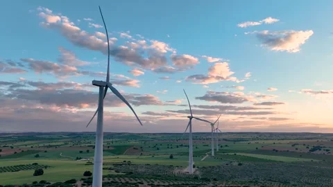 Side view of several wind turbines in a row at full capacity Stock Footage 274528102