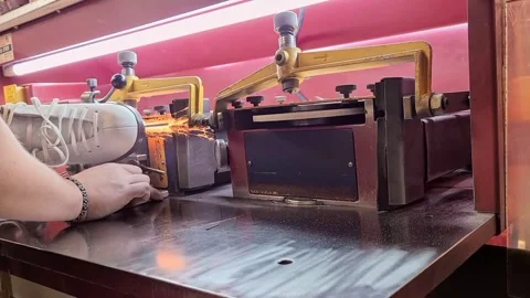 Side view of sharpening a figure skate and flying sparks. Stock Footage 252557301