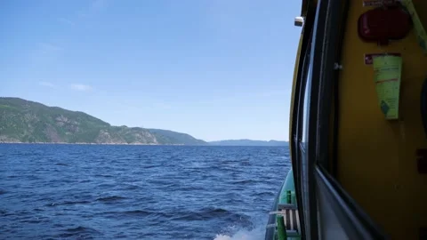 Side view of ship on river lake landscape mountains forest trees saguenay fjord Stock Footage 156145226