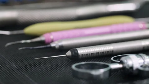 Side view shot of Dentist tools on black mat. In focus the edge of dental tool Stock Footage 131483584