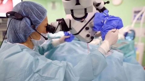 Side view shot of a experienced female surgeon using modern surgical microscope 库存影片 98364299