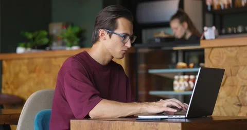 Side view shot of a freelancer typing on laptop keyboard in cafe Stock Footage 164172186