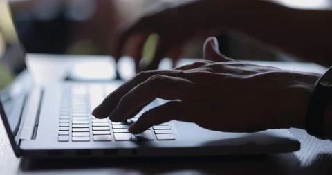 Side view shot of a freelancer's hands typing on laptop keyboard and using smart Video stock 163900880
