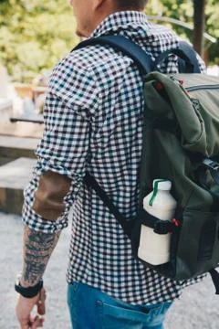 Side view shot. Man walking with plastic bottle of detox nutrition milk drink Stock Photos