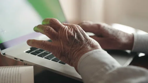 Side view shot of old wrinkled man's hands typing on computer keyboard Stock-Footage 195545112