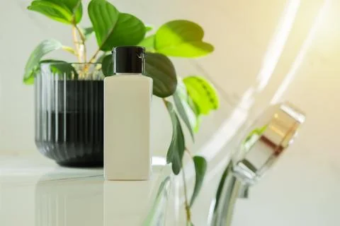 Side view shot of refill soap dispensers by bathtub in hotel room. Stock Photos
