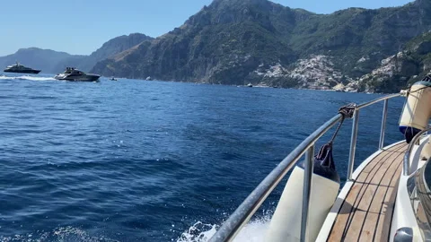Side view shot of riding speed boat along the Amalfi coastline in a sunny day 動画素材 345477702