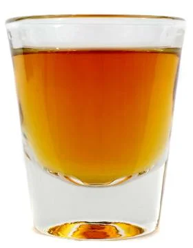 Side on view of shotglass of brandy Foto stock