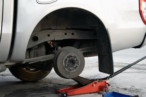The side view shows the jack and tools used to lift the vehicle and remove .. Стоковые фото