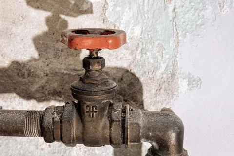 Side view of shutoff valve on exposed plumbing pipe Stock Photos