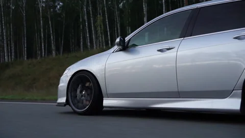 Side view of silver car rides on summer highway. Footage. Perfect auto drives 스톡 동영상 167960713