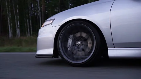 Side view of silver car rides on summer highway. Footage. Perfect auto drives Stockbeeldmateriaal 233625309