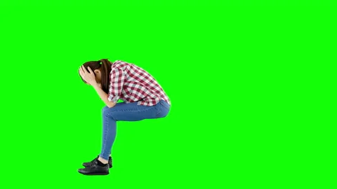 Side View of Sitting Brunette Wearing Checkered Shirt and Jeans Green Screen Stock Footage 137035217