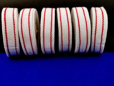 Side view of six White red cotton ribbon rolls. Used for clothing,packing,wra Stock Photos