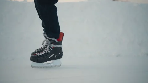 Side View Skater Gliding on Ice Rink with Snowbank in Background Stock Footage 316452360