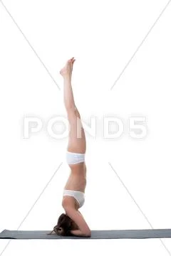 Side view of slender girl doing handstand Stock Photos
