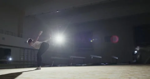 Side view of slim sportswoman doing back walkover exercise during gymnastic Stock Footage 138762048