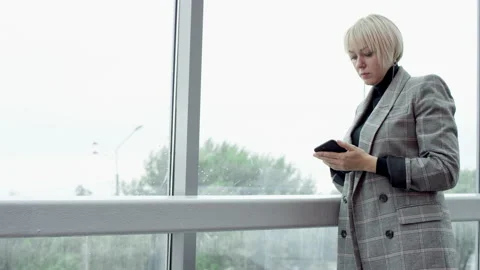 A side view slow motion close up video of a blonde business woman standing by Stock Footage 132450290