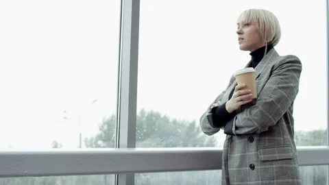 A side view slow motion close up shot of a young business woman drinking a Stock Footage 133463100