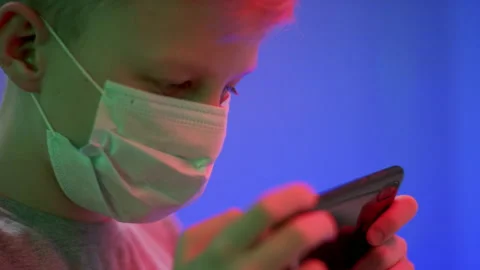 A side view slow motion close up shooting of a kid's face in a surgical mask Stock Footage 134425565