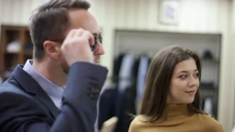 A side view slow motion close up of a middle-aged business man trying on two Stock Footage 134484563