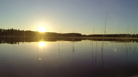 Side view from a slowly moving kayak during sunset at a lake Stock Footage 67989833