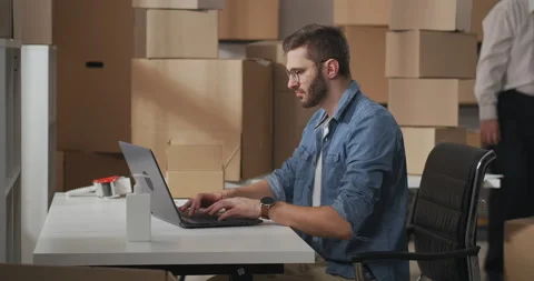 Side view of small business owners working together in a warehouse. Young man Stock Footage 149472855