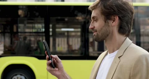 Side view of smiling bearded guy in formal wear typing messages on smartphone Stock Footage 137614893