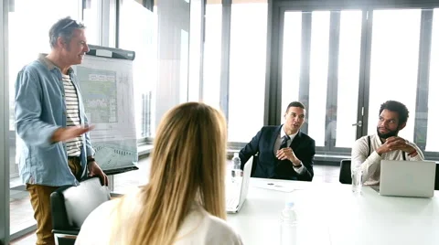 Side view of smiling creative director on a meeting with colleagues Stock Footage 59544082