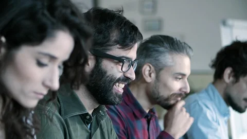 Side view of smiling developer in eyeglasses working with laptop 動画素材 121401323