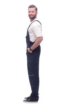Side view. smiling man in blue overalls. isolated on white Stock Photos