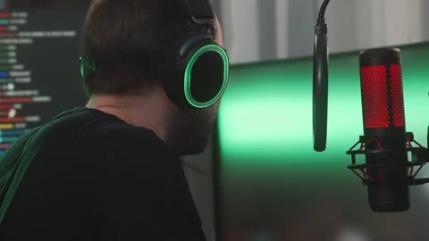 A side view of a smiling man gamer streaming online videogames on computer Stock Footage 154451598
